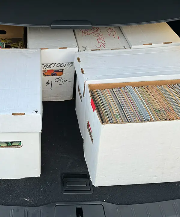 Long boxes of comics loaded in a vehicle